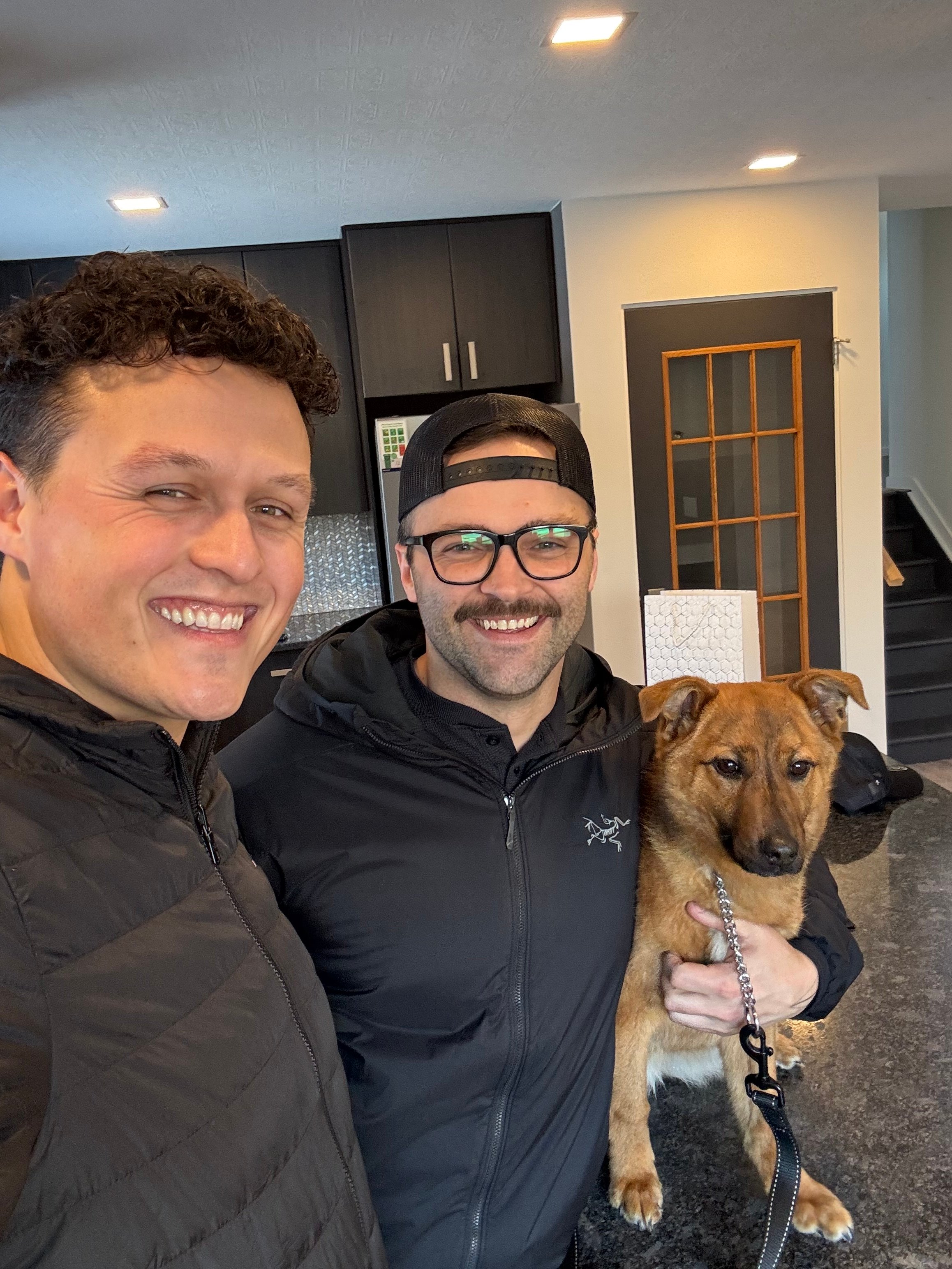 Talon Frick with clients and their dog — first home possession day Regina