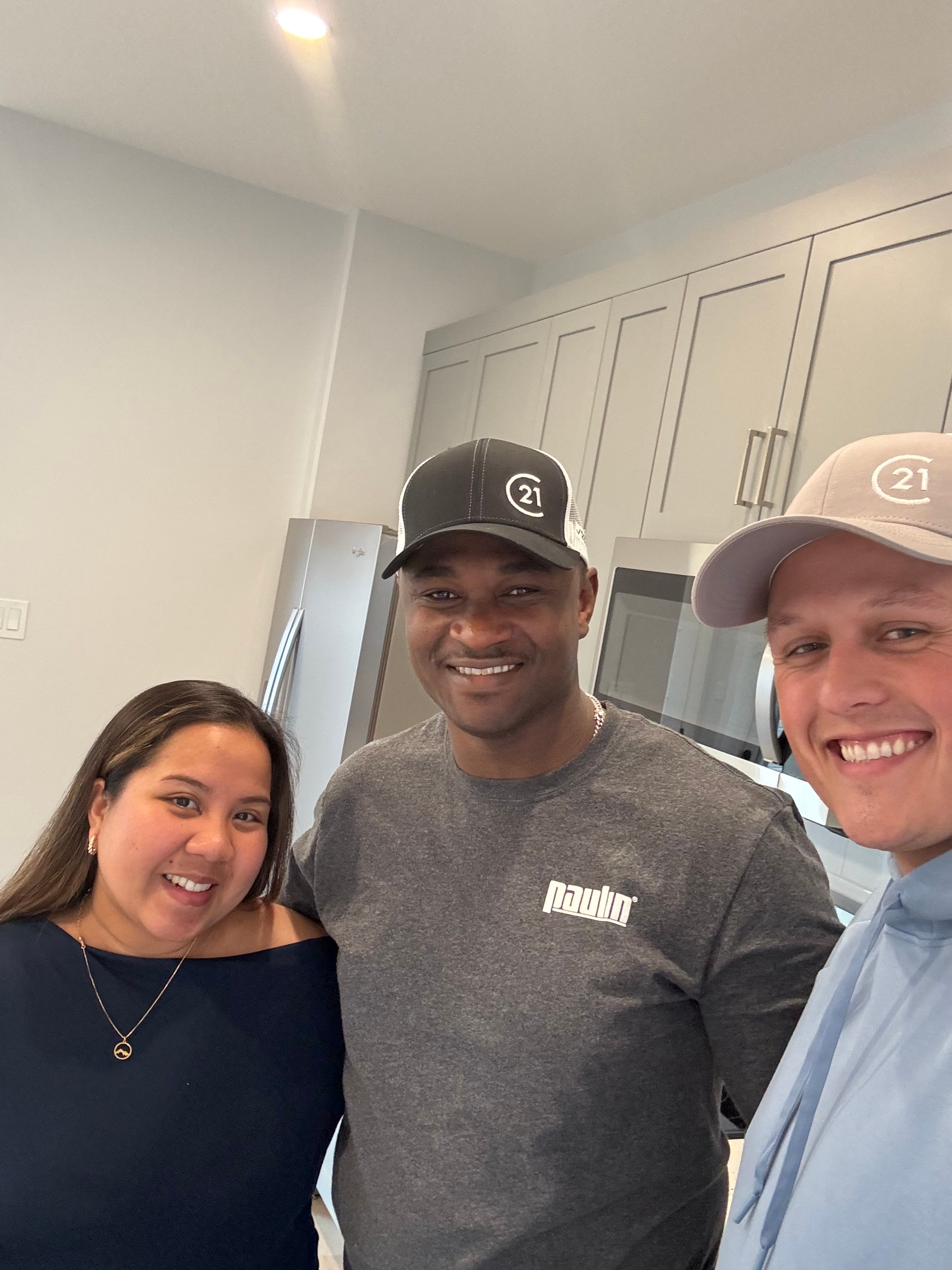 Talon Frick with clients inside new home — possession day Regina