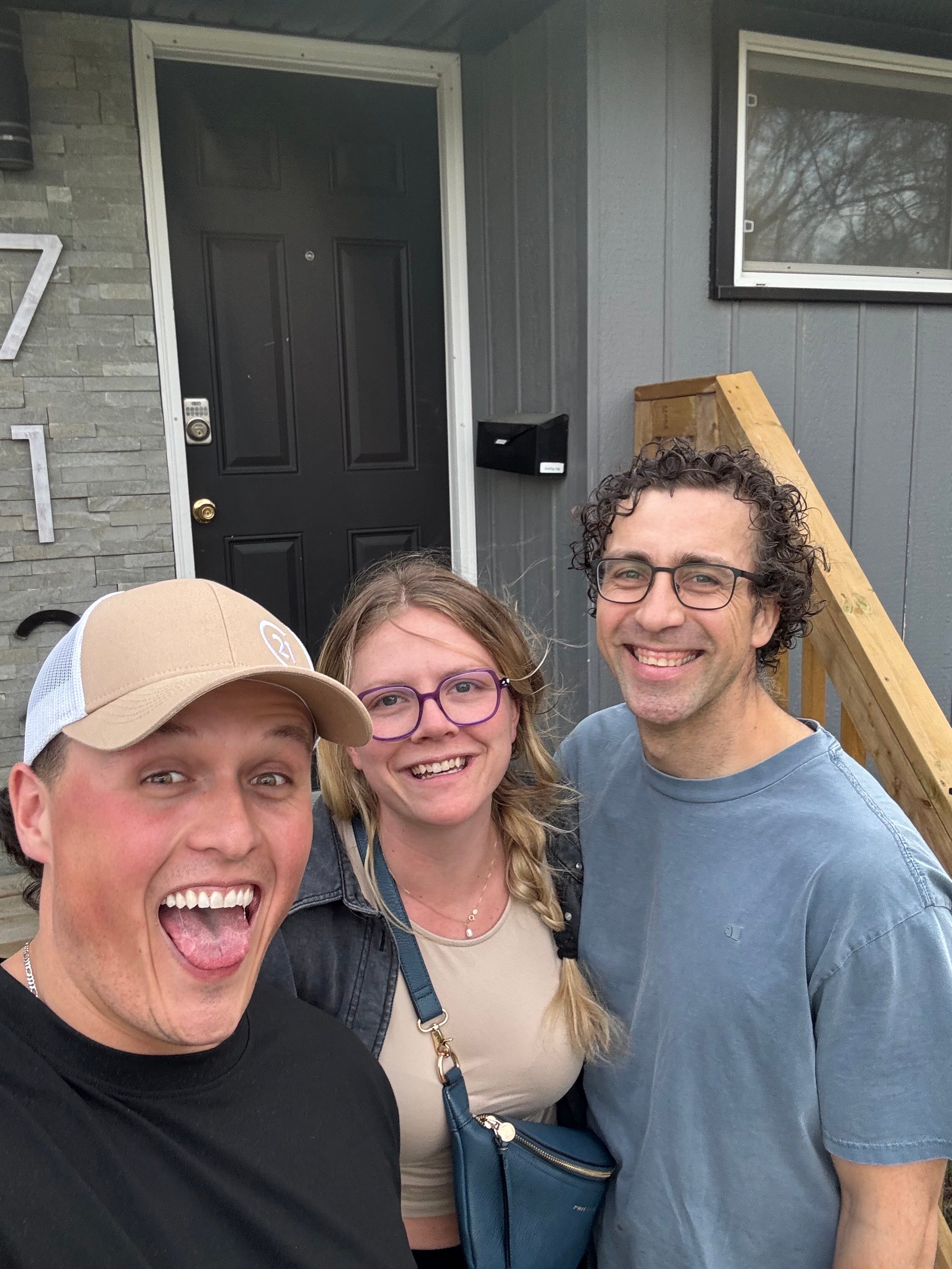 Talon Frick with clients at front door — possession day Regina